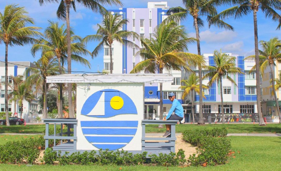 The author sitting on a sign near Miami Beach Florida