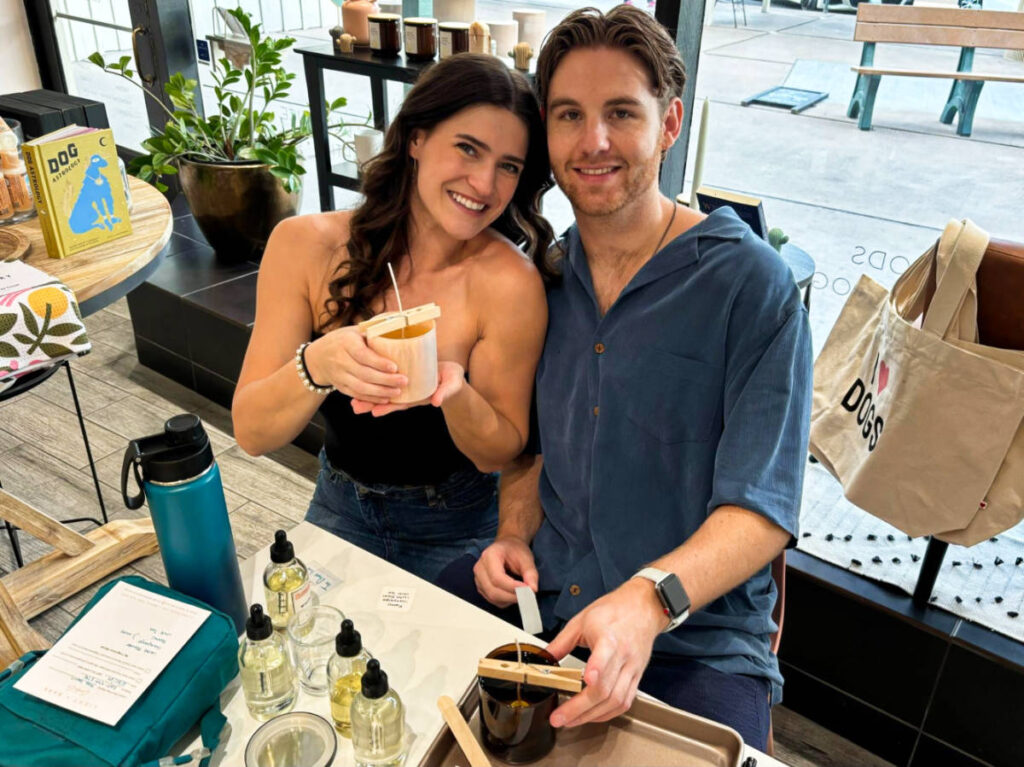 The author Betty Hurd and her fiancé Michael showing off the candles they made in Light + Bark