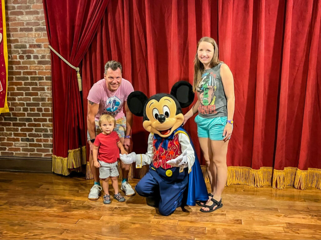 Author Katie Neufeld and her family taking a picture with Mickey Mouse