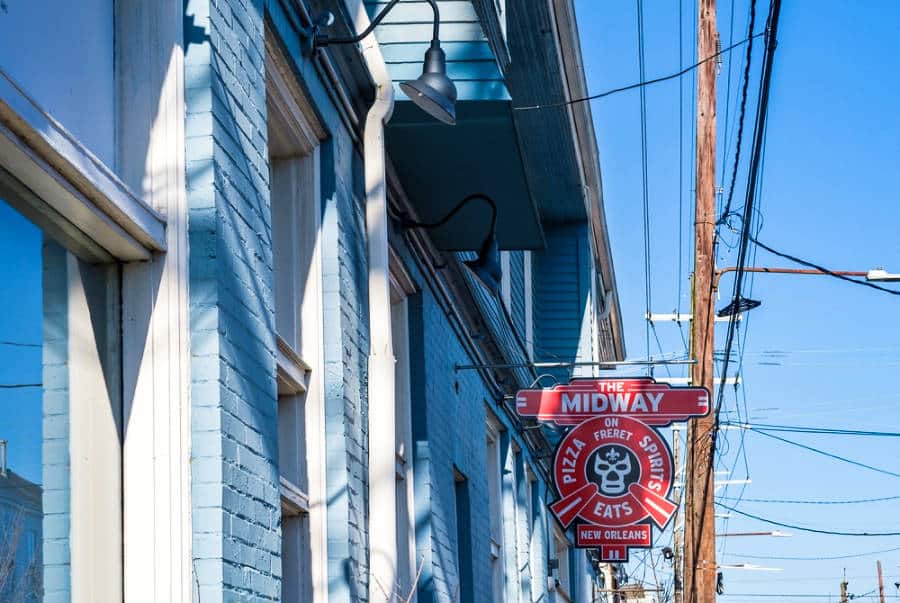 View of the hanging outdoor signage of Midway Pizza