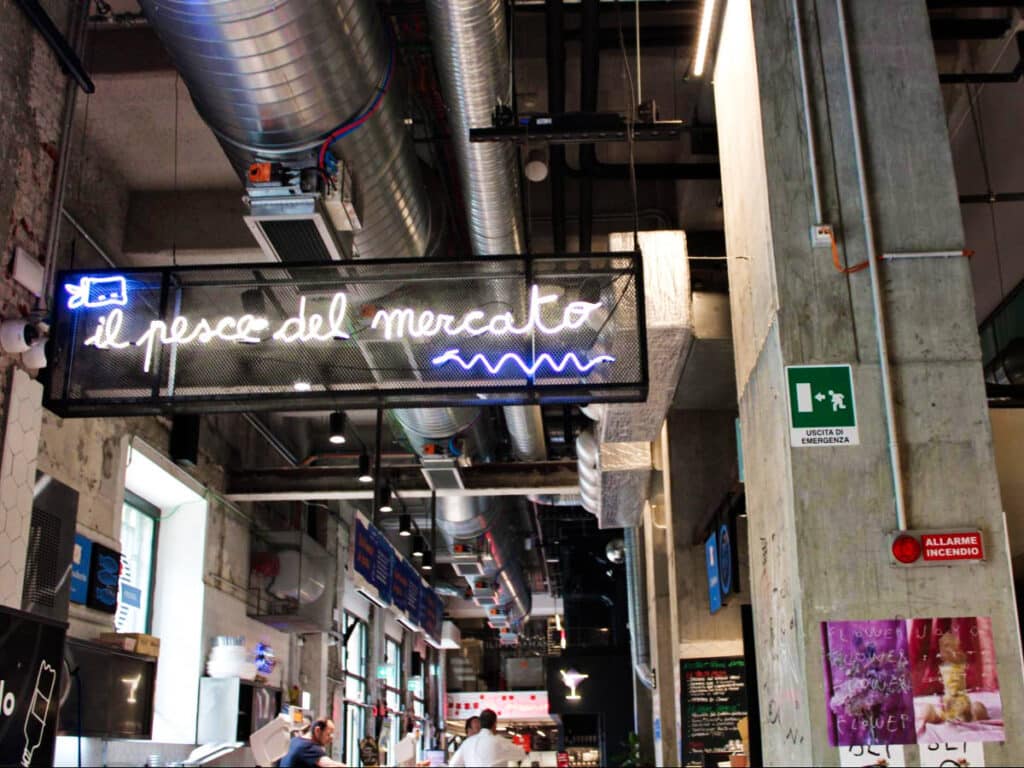 A neon signage at the Milan Central Market in the train station