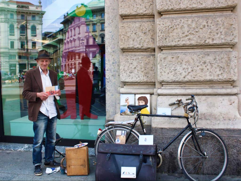 A local painter holding his art work in Milan