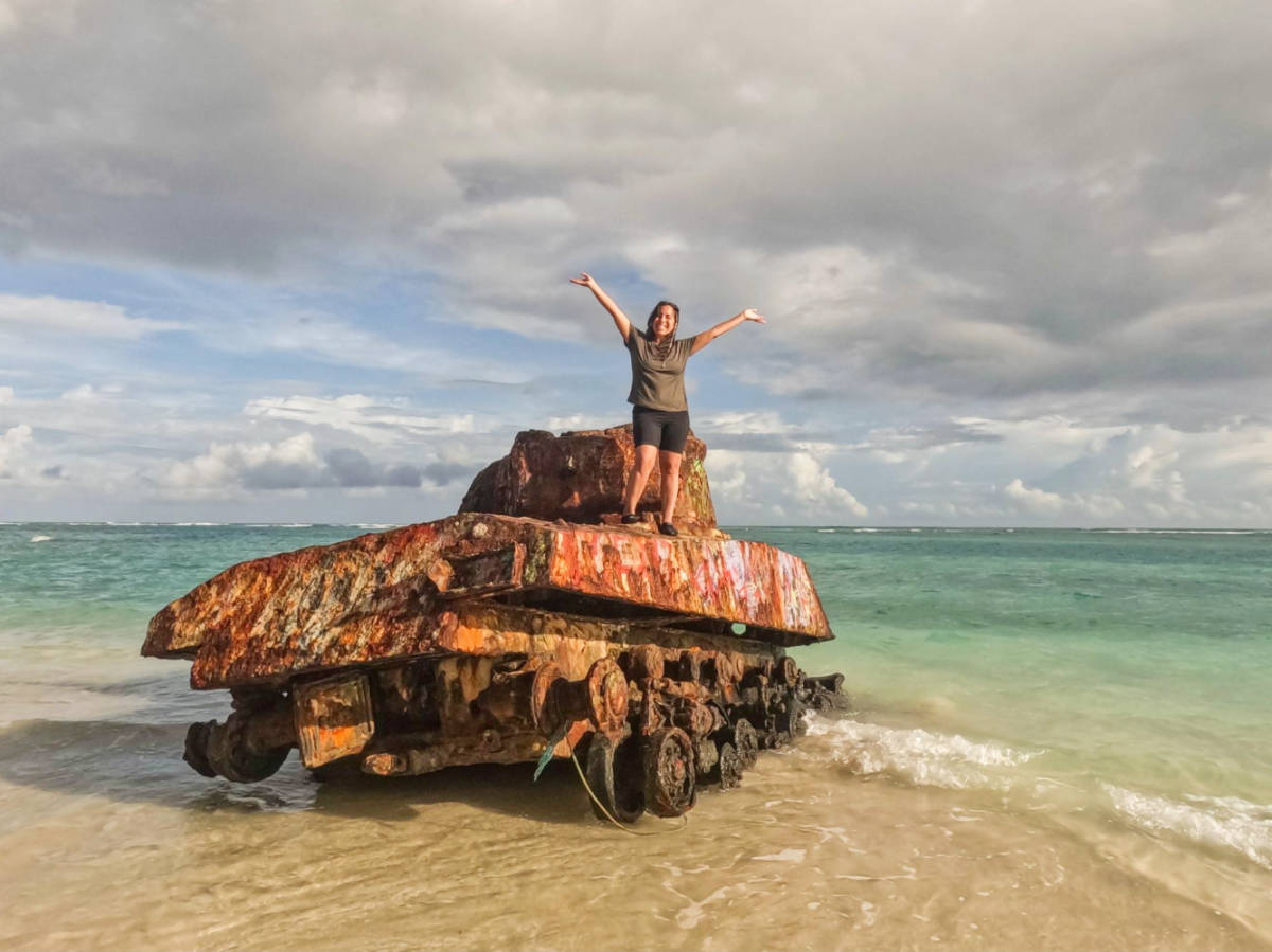 The author Vanessa Ramos on the military tank in Playa Flamenco
