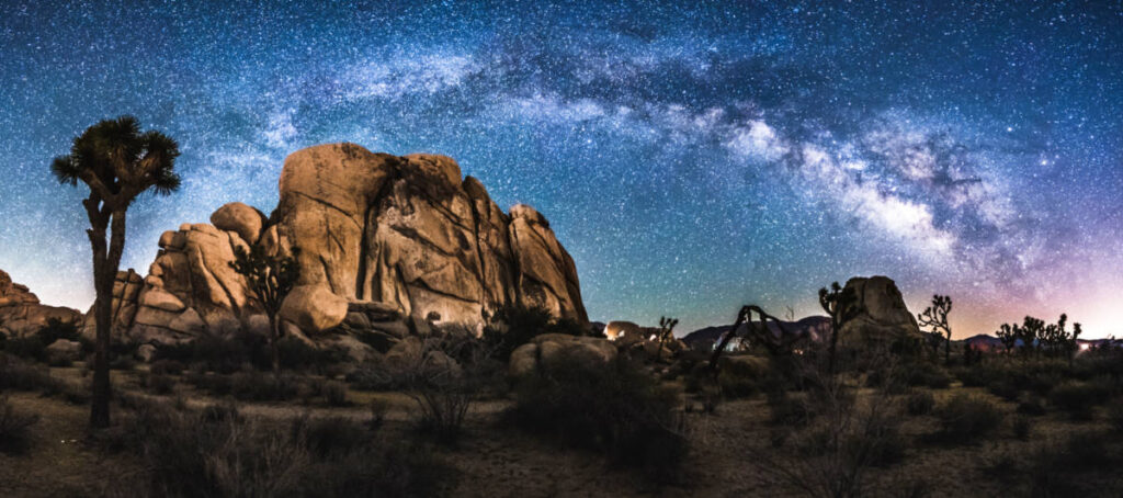 Panoramic view of the Milky Way arch over the Joshua Tree National Park