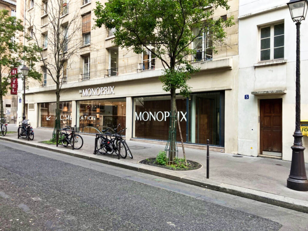 View of the storefront of Monoprix from across the street in Paris