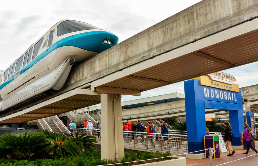 View of a monorail in Disney World and people going to it