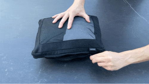 A GIF of Nate opening his Monos compression cubes