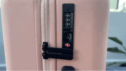 Clara opening the TSA lock of their Monos Luggage