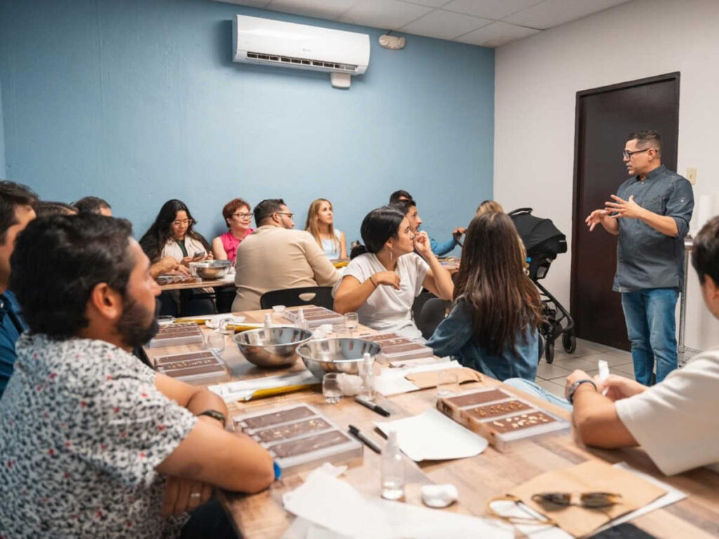 A mentor teaching a group of people at a Montadero Chocolate class