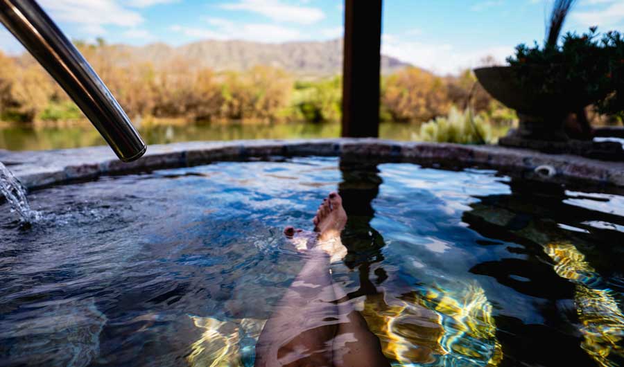 A woman soaking on a hot spring pool in Montezuma Hot Springs