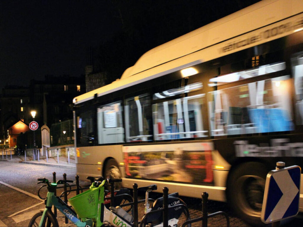 A bus passing by in Montmartre at night