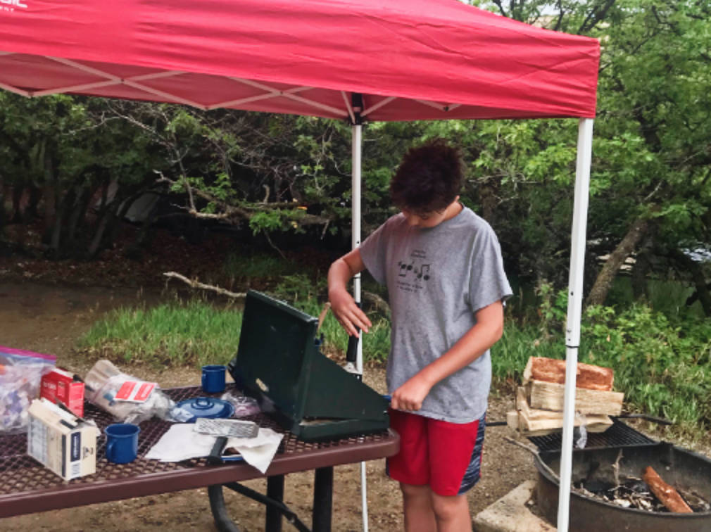 The author's son preparing a breakfast at Morefield Campground
