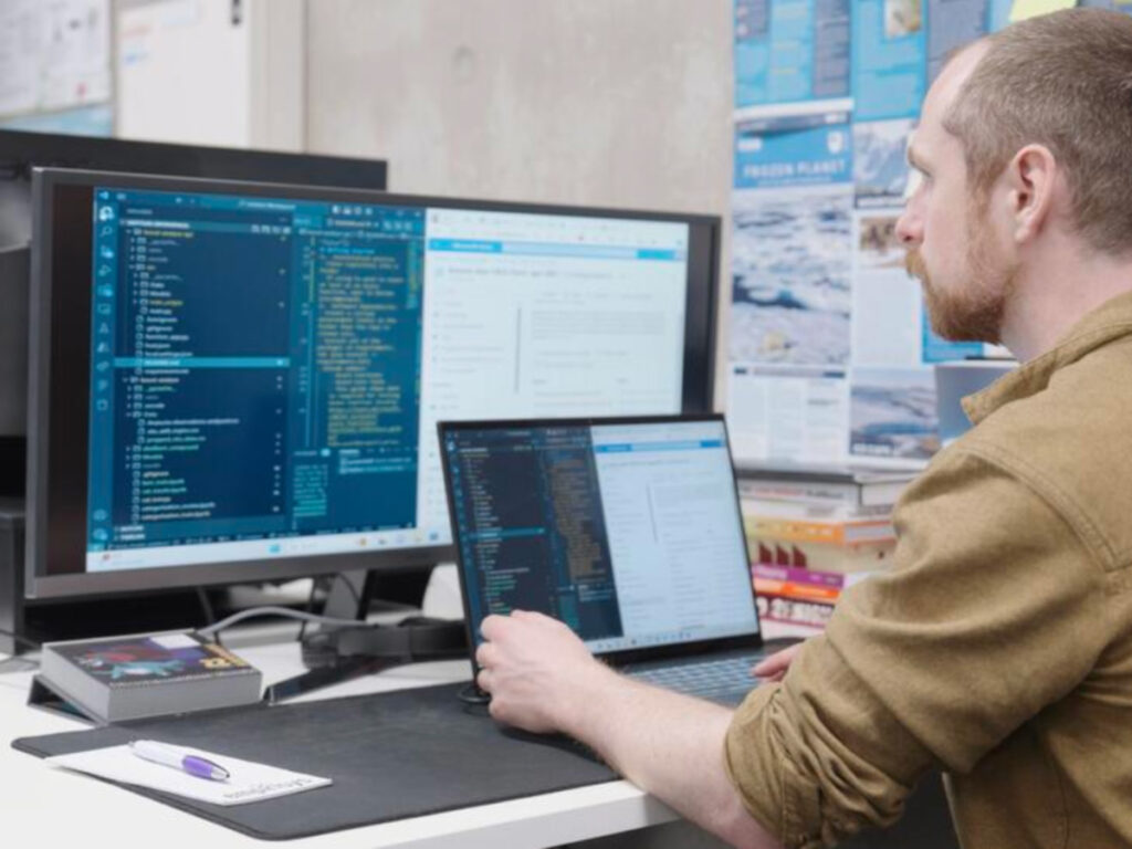 Morgan working with two screens