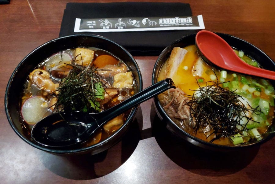 Two different bowl of ramen on a table