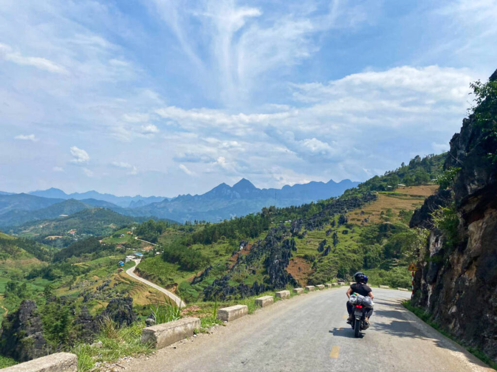 The people on a motorbike ride along the Ha Giang Loop with overlooking mountain views
