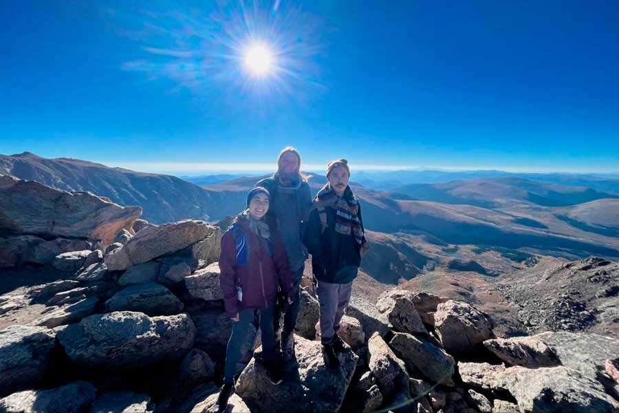 Abigail with her husband and brother at the summit of Mount Bierstadt