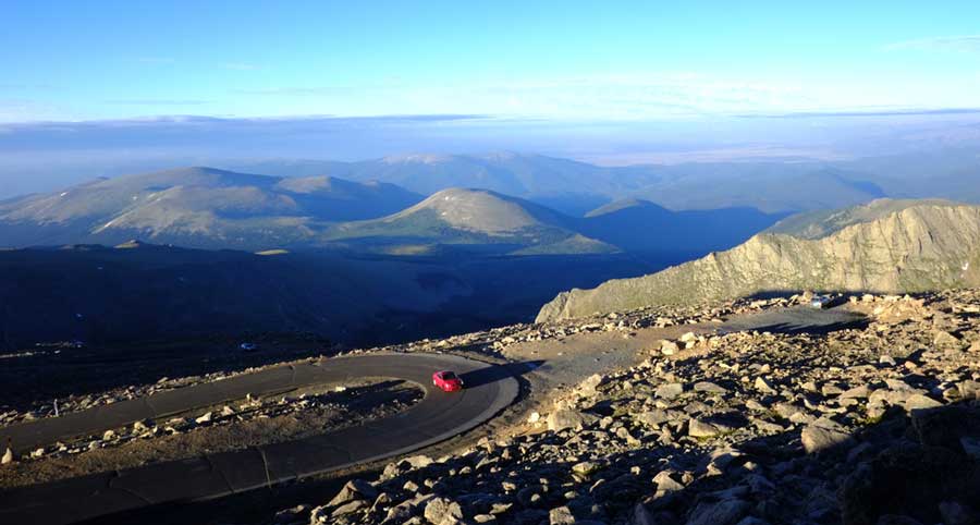 A red car driving in the Mount Evans Scenic Byway