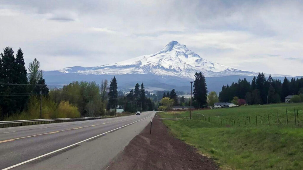 View of the lush landscape near the road with a scenic view of Mount Hood