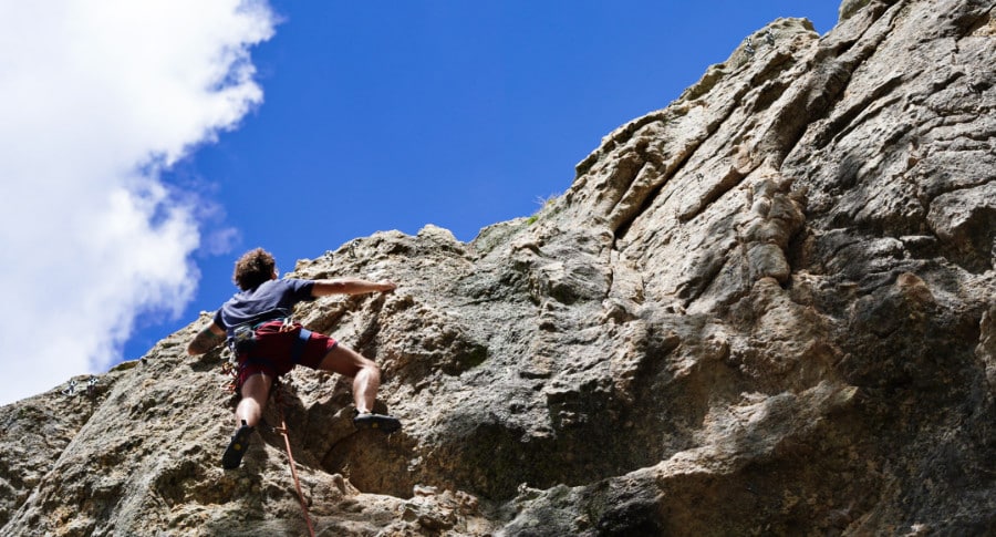 A man rock climbing into Mount Lemmon.