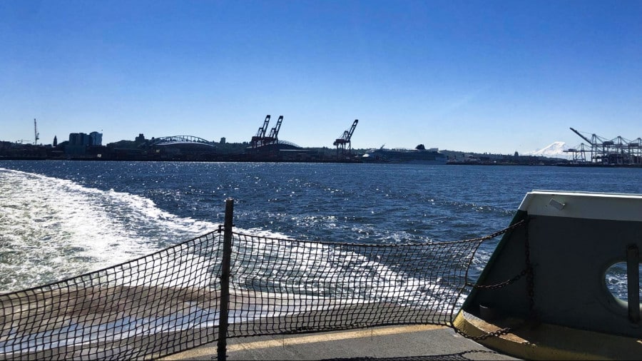 View of Mount Rainier in the distance from the back of a ferry ride on a sunny day