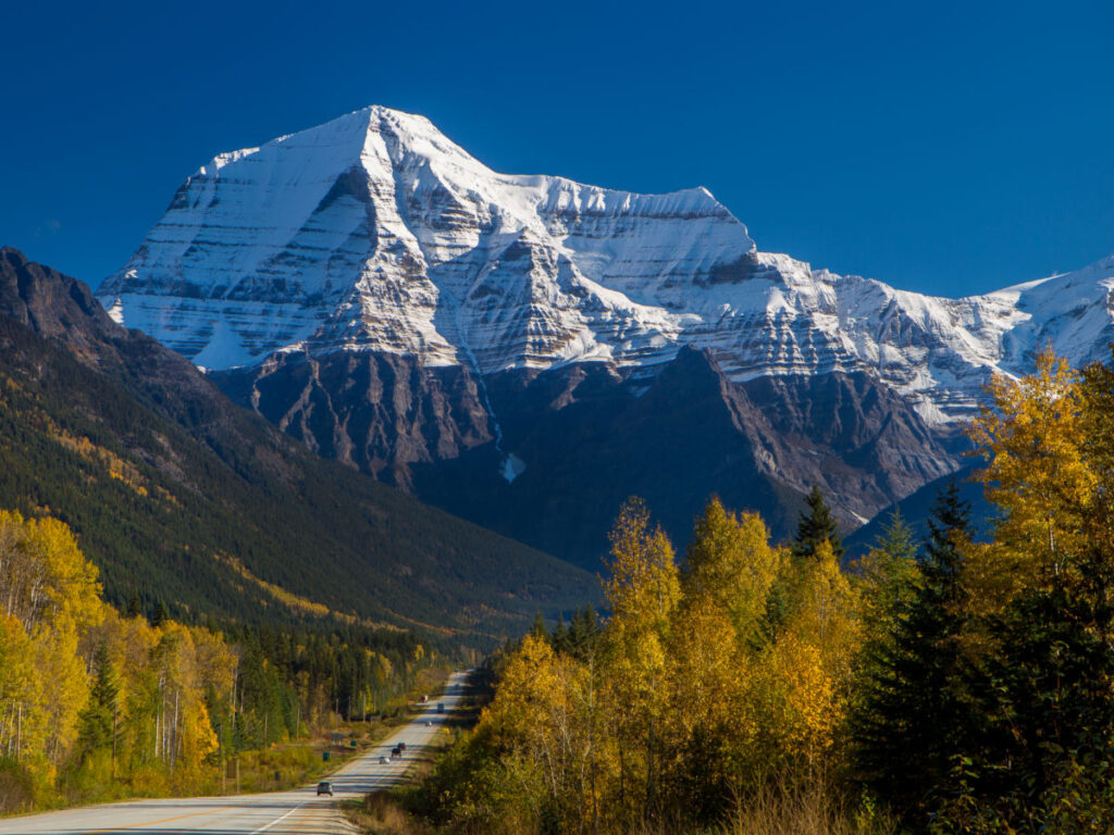 Mount Robson covered in snow, standing tall against a blue sky in Valemount