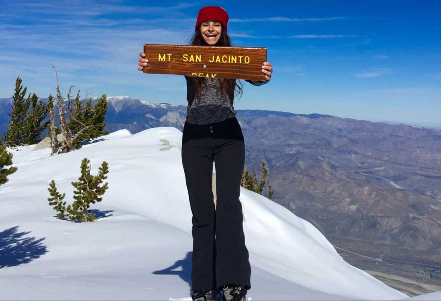 The author holding the Mt. San Jacinto Peak signage at the top of it during winter