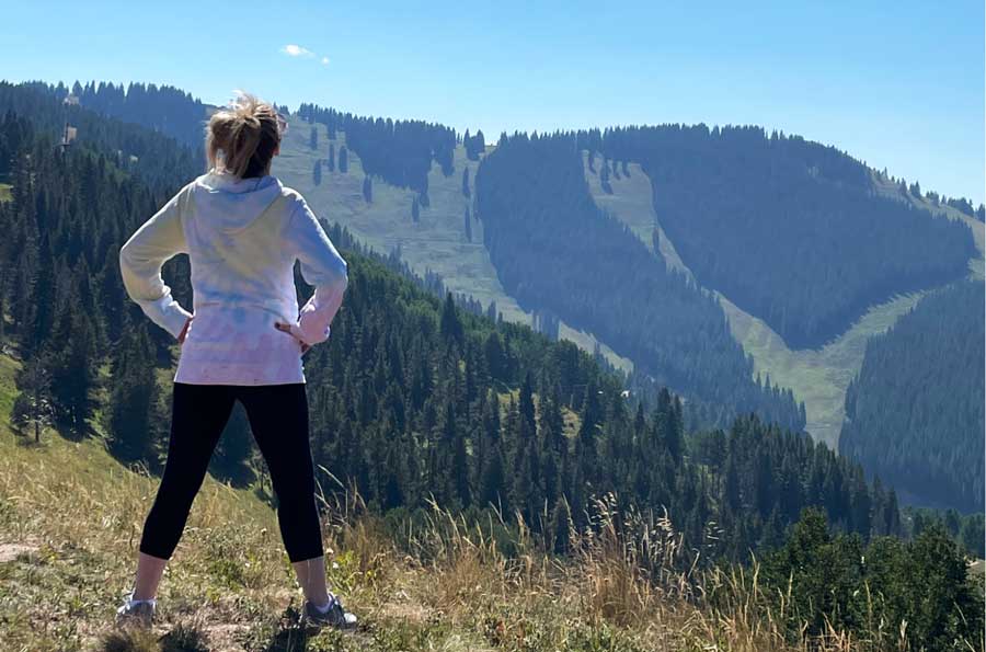 A young woman admiring the mountain view in Vail