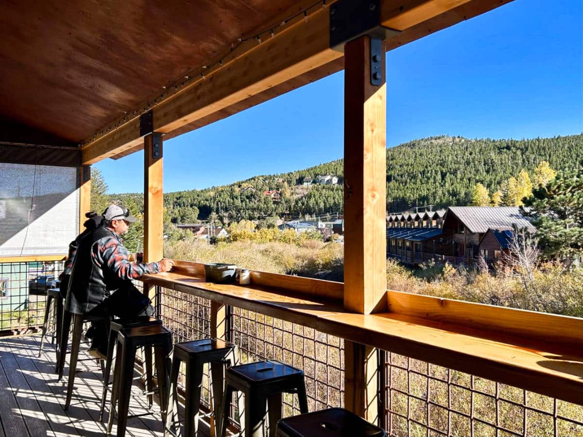 View of the people dining with mountain views at the outdoor patio of Crosscut Pizzeria and Taphouse