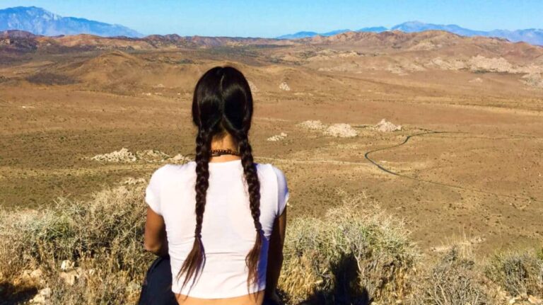 The author McKenna Mobley watching the scenic mountain ranges view in her visit to Joshua Tree