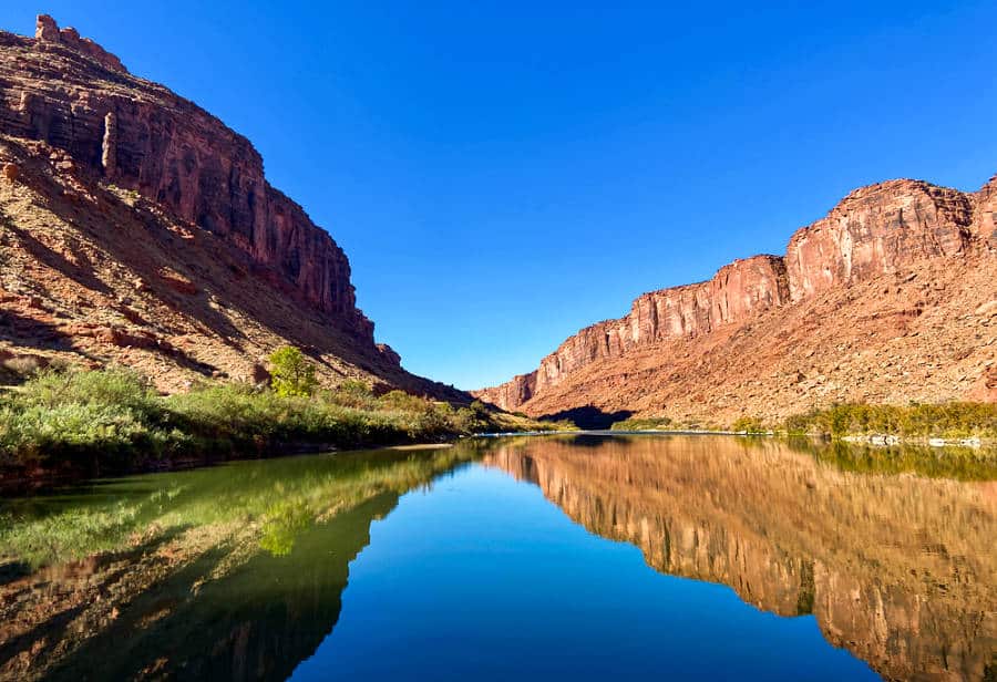 View of the red rocks canyon reflecting on the Colorado River