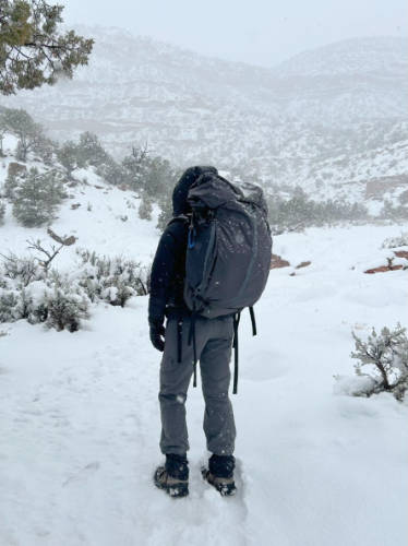 The author's friend using the Mountainsmith Apex 60 during winter