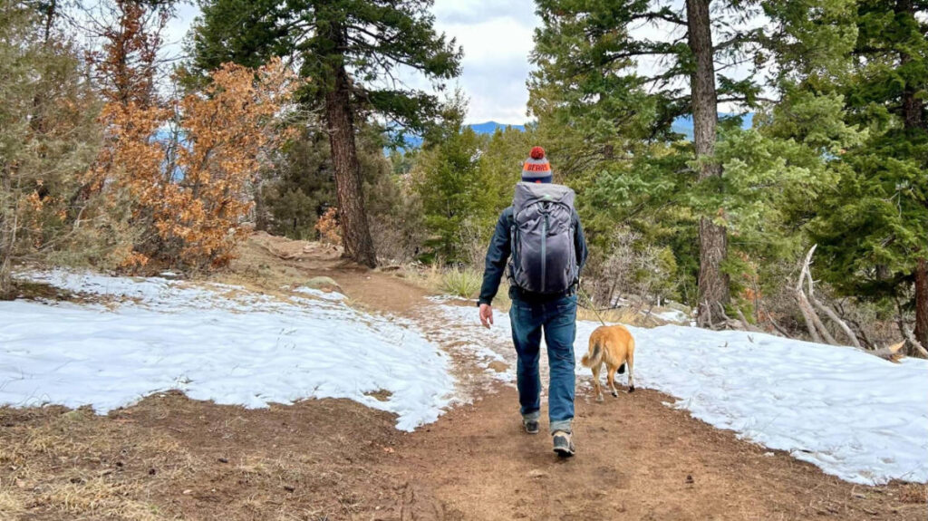 The author's husband with the Mountainsmith Apex Backpack and their dog