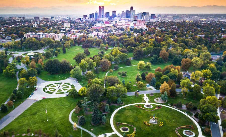 Aerial view of Denver cityscape and city park at sunset