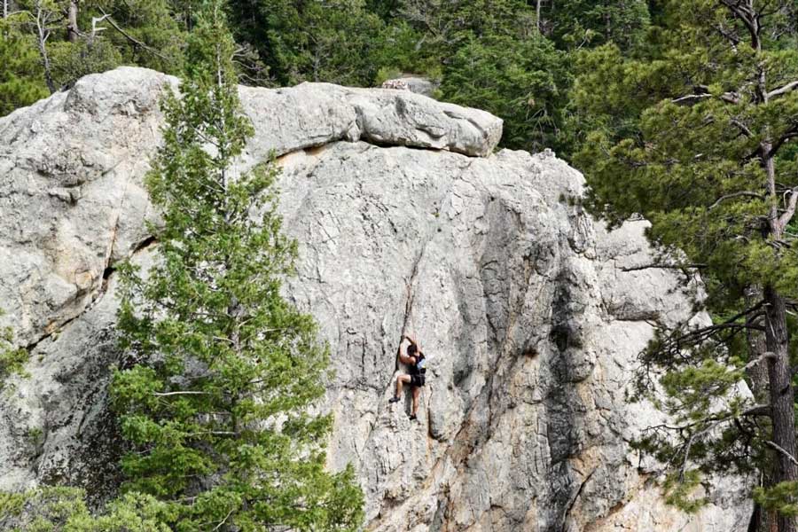 A man climbing to the top of Mt. Lemmon