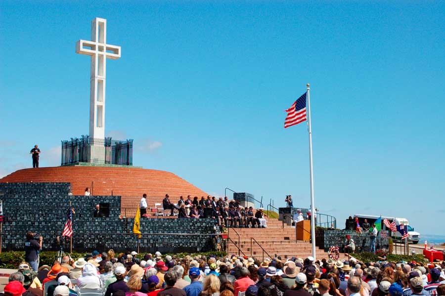 A big cross and people attending a ceremony in Mt. Soledad National Veterans Memorial