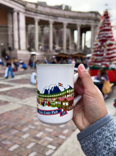 A hand holding a collectible mug at Denver Christkindl Market