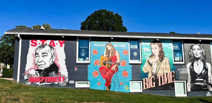 Hand painted posters of different artists outside Grimey’s