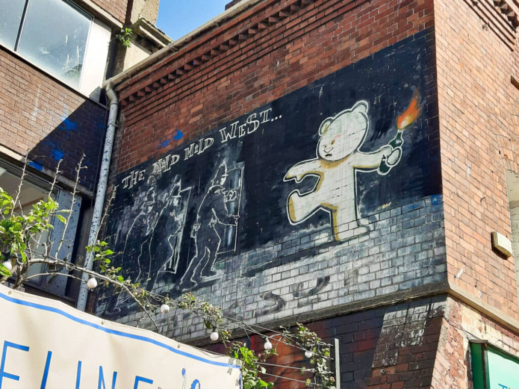 A mural on the building, The Mild Mild West by Banksy
