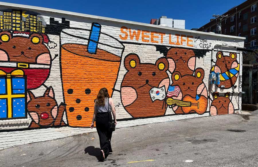 The author looking at the colorful mural in Nashville