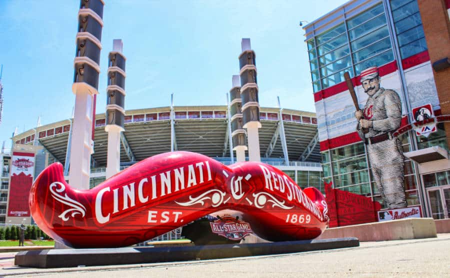 A huge red mustache sculpture with the Great American Ballpark in background