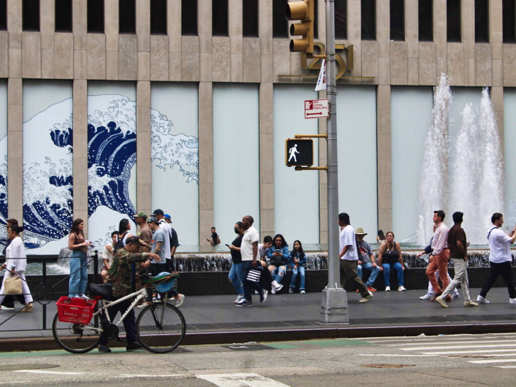 View of the mural and the people walking around NYC