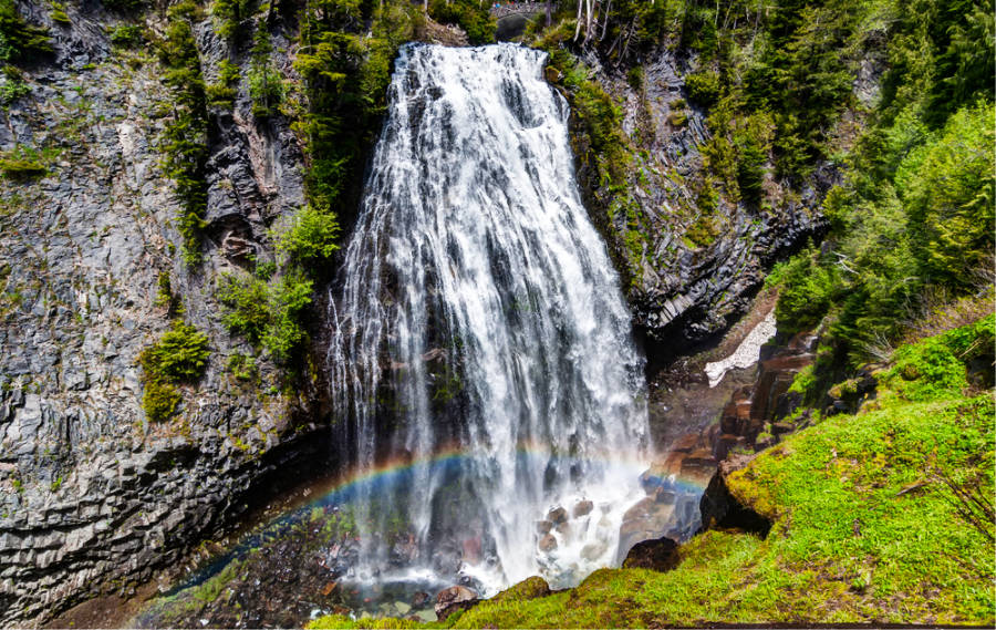 Scenic view of Narada Falls with a beautiful rainbow in Mt Rainier National Park