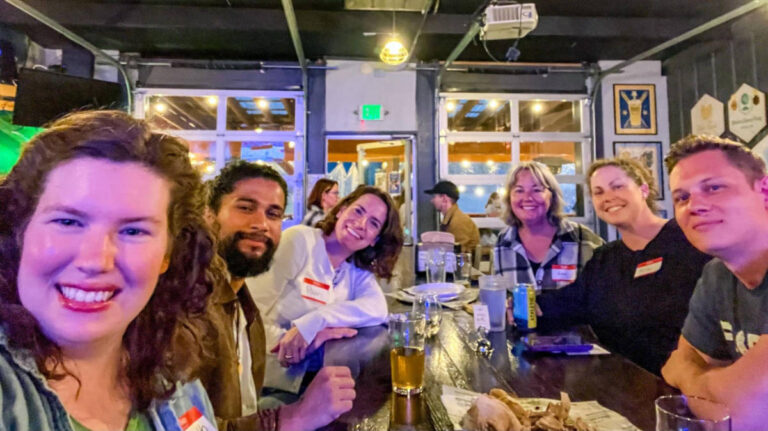 People smiling for a photo during the Travel Lemming's Nashville Community Meetups