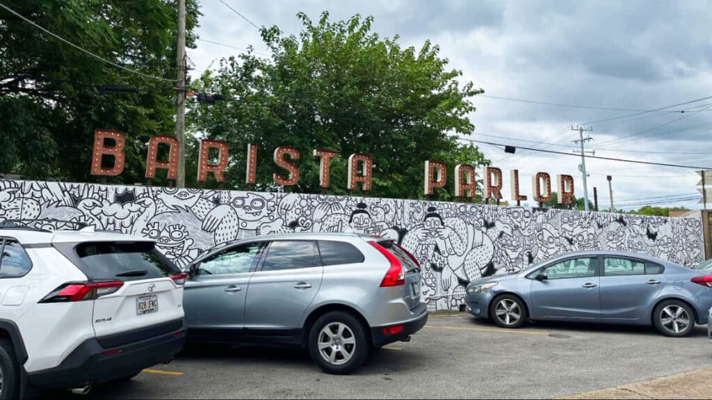 Parked cars near a mural painted wall at Barista Parlor in Nashville