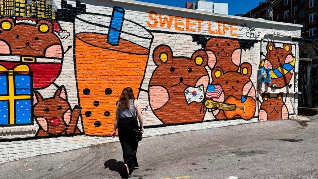 The author walking a street with colorful murals