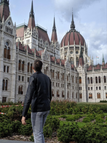 Travel Lemming founder, Nate Hake, admiring the intricate exterior of the Parliament Building