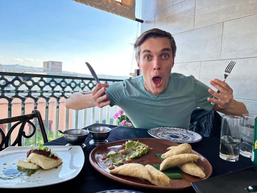 Travel Lemming Founder Nate Hake holding his fork and knife while dining in Querétaro