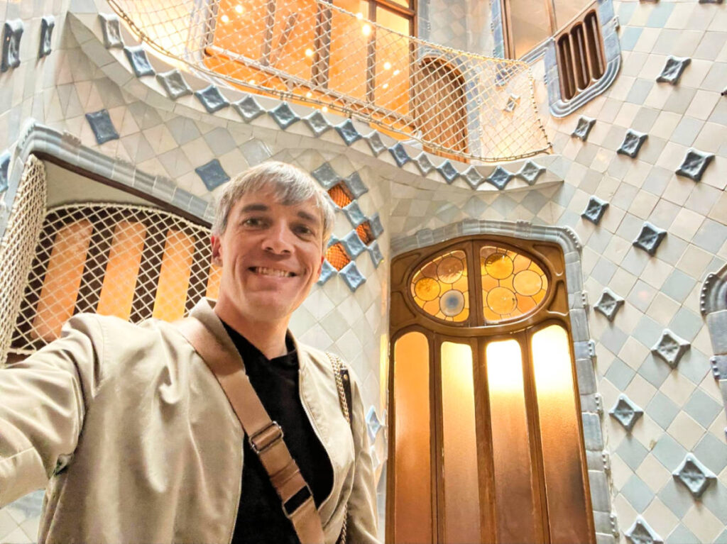 Travel Lemming Founder Nate Hake, showing off the intricate tile interior of Casa Batlló