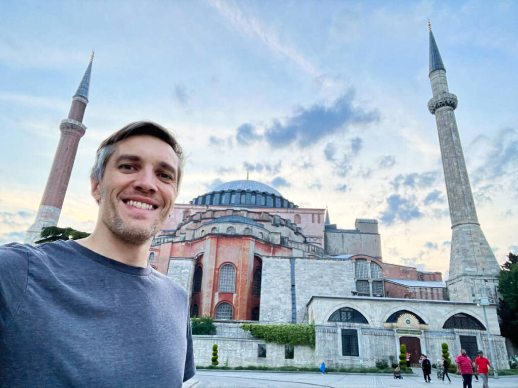 Travel Lemming founder Nate Hake, smiling for a photo outside the iconic Hagia Sophia mosque in Istanbul
