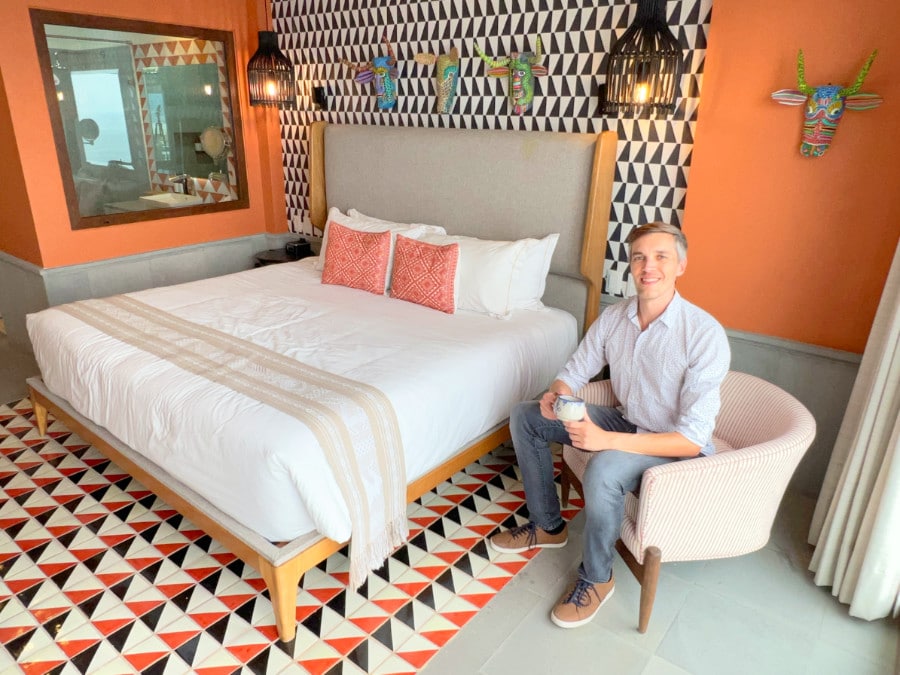 Nate sitting on a chair inside a bedroom in Patio Azul